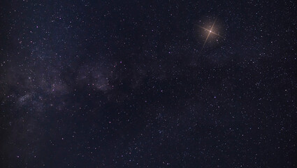 Wall Mural - christmas star rising near the milky way