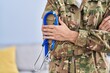 © Krakenimages.com - Young hispanic man army soldier doctor holding stethoscope at home