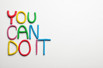 Wall Mural - Motivational phrase You Can Do IT made of colorful plasticine on white background, flat lay. Space for text