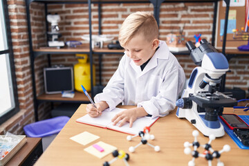 Poster - Adorable toddler student smiling confident writing on notebook at classroom