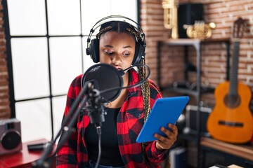 Sticker - African american woman musician singing song using touchpad at music studio