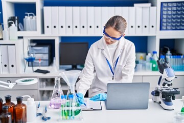 Sticker - Young woman scientist writing on clipboard at laboratory