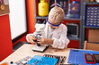 © Krakenimages.com - Adorable toddler student using microscope standing at classroom