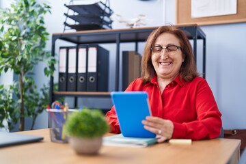 Poster - Senior woman business worker using touchpad working at office