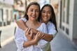 © Krakenimages.com - Two women mother and daughter smiling confident hugging each other at street