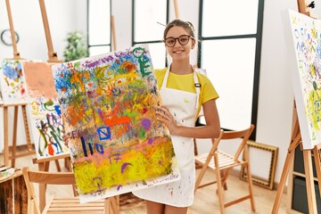 Poster - Adorable girl smiling confident holding canvas draw at art studio