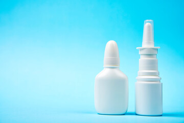 Wall Mural - Nasal spray bottle on blue background with copy space