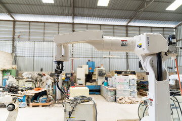 Wall Mural - Automatic robot arm system welding machine in the industry factory. Industry robot manufacturing technology