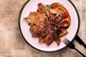 Sticker - Top view of plate with fried beef liver with caramelized onions, garlic and sage.