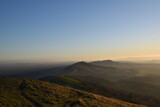 Fototapeta Góry - the top of the Malvern hills on a misty day during sunset