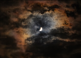 Wall Mural - The Moon in the night sky is surrounded by colored clouds. Halo - light phenomenon of nature