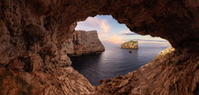 Cave On Rocky Coast With Cliffs On The Mediterranean Sea. Sunset Sky Art Render. Regional Natural Park Of Porto Conte, Sardinia, Italy. Nature Background.