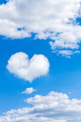 Wall Mural - clouds on a blue sky with a heart shaped cloud. vertical frame