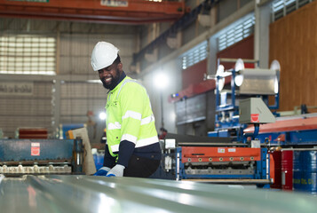 Young engineers engineers testing and confirming that the machinery at the factory