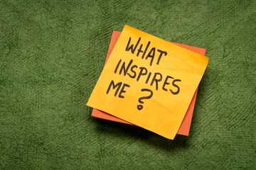 Wall Mural - What inspires me? Handwritten question on a sticky note. Inspiration and personal development concept.