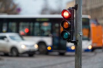 Wall Mural - view of city traffic with traffic lights, in the foreground a traffic light with a red light