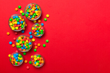 Poster - different colored round candy in bowl and jars. Top view of large variety sweets and candies with copy space