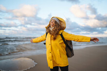 Happy Tourist In A Yellow Jacket  Enjoying Sea Landscape. Travelling, Lifestyle, Adventure.