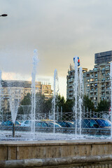 Wall Mural - Fountain at Unirii Square in downtown of Bucharest.  Unirii Boulevard in Bucharest, Romania, 2021