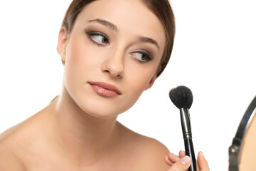 Poster - Woman using make-up brush, isolated on white background