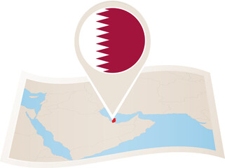 Wall Mural - Folded paper map of Qatar with flag pin of Qatar.