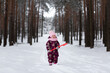 © Константин Чернышов - A little girl stands in the middle of a snowy forest with a red shovel in her hands. Looks into the frame. Winter. Snowdrifts are white.