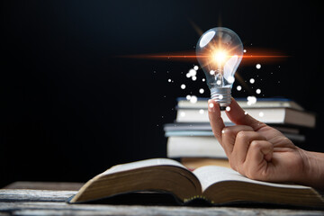 Wall Mural - Light bulbs and books. Concept of reading books, knowledge, and searching for new ideas. Innovation and inspiration, Creativity with twinkling lights, the inspiration of ideas.