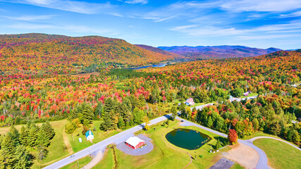 Wall Mural - Aerial over road and endless colorful peak fall hills of New York