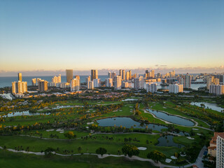 city skyline at sunset with golf course foreground