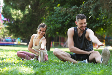 Canvas Print - Man and woman doing morning exercise in park