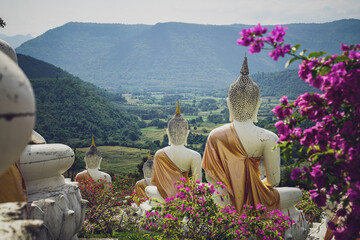 beautiful white stucco Buddha statue  enshrined on the hillside  It is a place of meditation called Wat Sutesuan, Nam Nao District, Thailand.