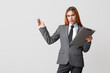 © Pixel-Shot - Beautiful transgender secretary with clipboard on grey background