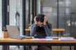 © David - Portrait of tired young business Asian woman work with documents tax laptop computer in office. Sad, unhappy, Worried, Depression, or employee life stress concept