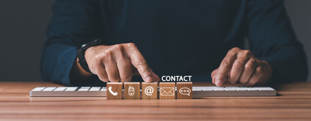Banner, web for contact us or e-mail marketing concept, Customer support hotline Contact us people connection. cube wood with the email, call phone, address, Chat message icons. on keyboard computer.