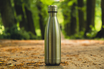 Wall Mural - Water bottle. Reusable steel thermo water bottle on green grass. Sustainable lifestyle. Plastic free zero waste free living. Go green Environment protection. Health-conscious. Steel thermo water