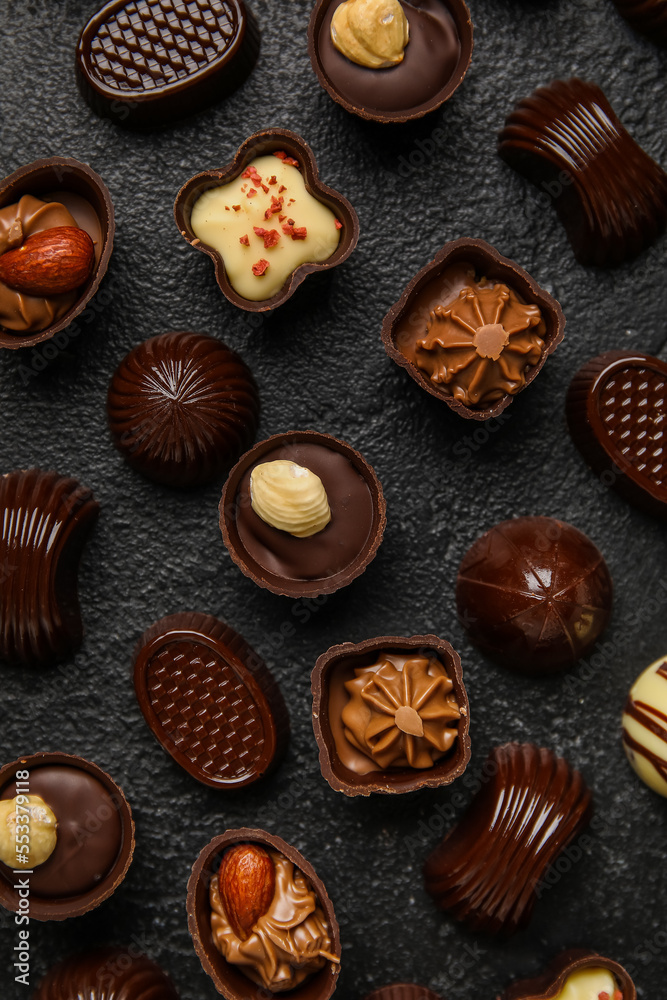 Different chocolate candies on black background
