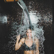 Woman Taking a Cold Shower from Ice Bucket.