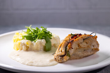 Wall Mural - turkey roll filled with spinach and ham served with mashed potatoes and cream sauce