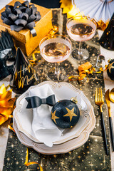 New year table setting with decoration for dining and party in black and golden tone