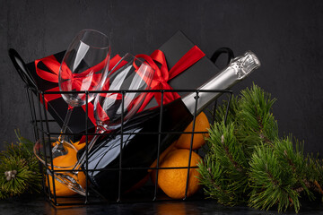 Wall Mural - Basket with Christmas gift boxes, champagne, oranges