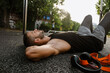 © Drobot Dean - Tired sportsman resting after workout while lying on a ground on sports court