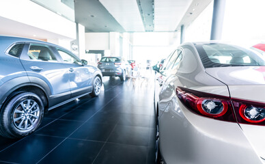 Rearview car parked in luxury showroom. Car dealership office. New car parked in modern showroom. Car for sale and rent business concept. Automobile leasing and insurance concept. Electric automobile.