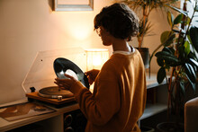 Brunette Young Woman In Eyeglasses Using Stereo Turntable