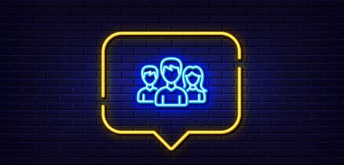 Neon light speech bubble. Group line icon. Users or Teamwork sign. Male and Female Person silhouette symbol. Neon light background. Teamwork glow line. Brick wall banner. Vector