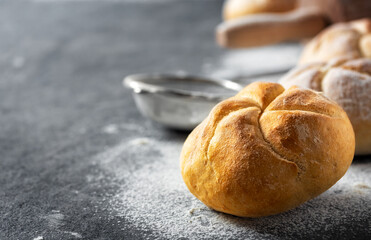 Aufkleber - Close up of fresh small bun bread on the dark table with copy space. Home baking concept
