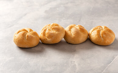 Aufkleber - Set of fresh mini buns on a light table. Home baking concept
