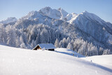 Fototapeta Las - Wooden cabin or hut in the mountains in winter in the Austrian Alps.