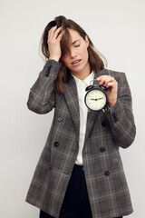 Wall Mural - Depressed businesswoman holding a clock. Time and deadlines showing stress and burnout at work.