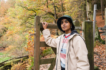 Wall Mural - Female hiker walking through gate in forest