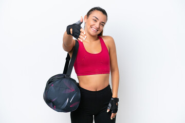 Wall Mural - Young sport woman with sport bag isolated on white background shaking hands for closing a good deal